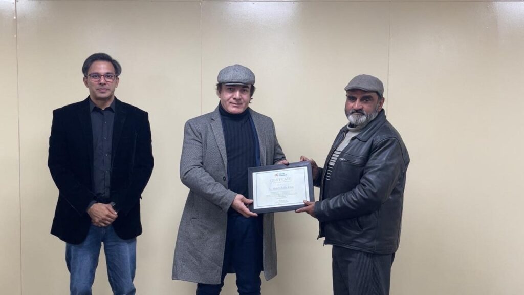 Deputy Regr. of UOR awarding certificates to Salman Shehzad, Project Director NFLP-Y, and Dr. Abdul Ghaffar Khan