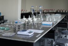 Doctor of Pharmacy (Pharm.D.) at UOR: Unlock Your Future as a Pharmacist Pharmacy laboratory station at UOR with flasks, jars, and equipment for formulation and pharmaceutical analysis.