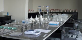 Doctor of Pharmacy (Pharm.D.) at UOR: Unlock Your Future as a Pharmacist Pharmacy laboratory station at UOR with flasks, jars, and equipment for formulation and pharmaceutical analysis.